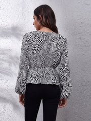 Black and white leopard print peplum blouse with gathered waist and balloon sleeves.