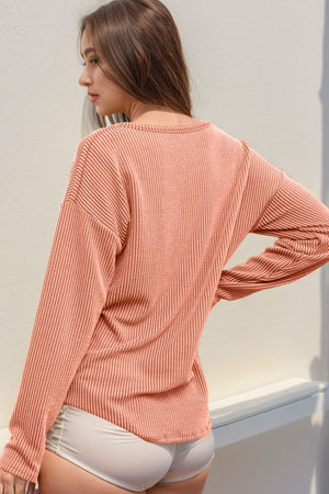 Coral ribbed long sleeve top with a crew neck.