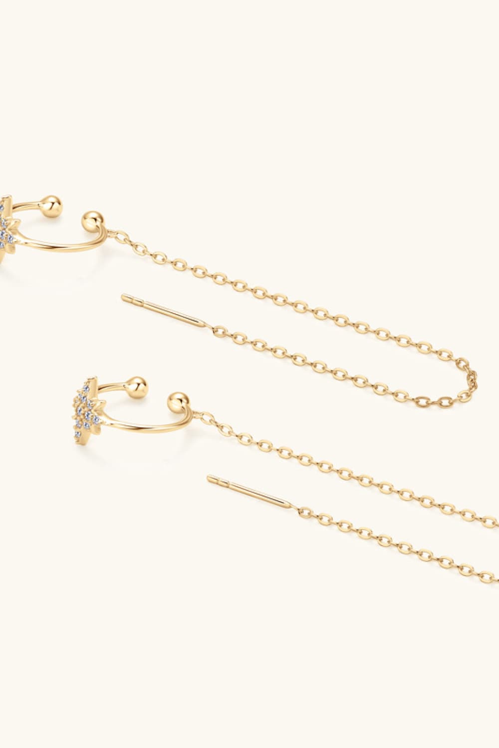Gold threader earrings with moissanite starbursts and long chain details.