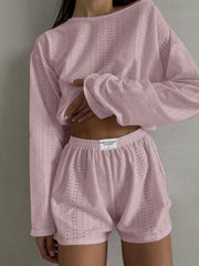 Blush pink perforated crop top and shorts set with long sleeves and elastic waistband.