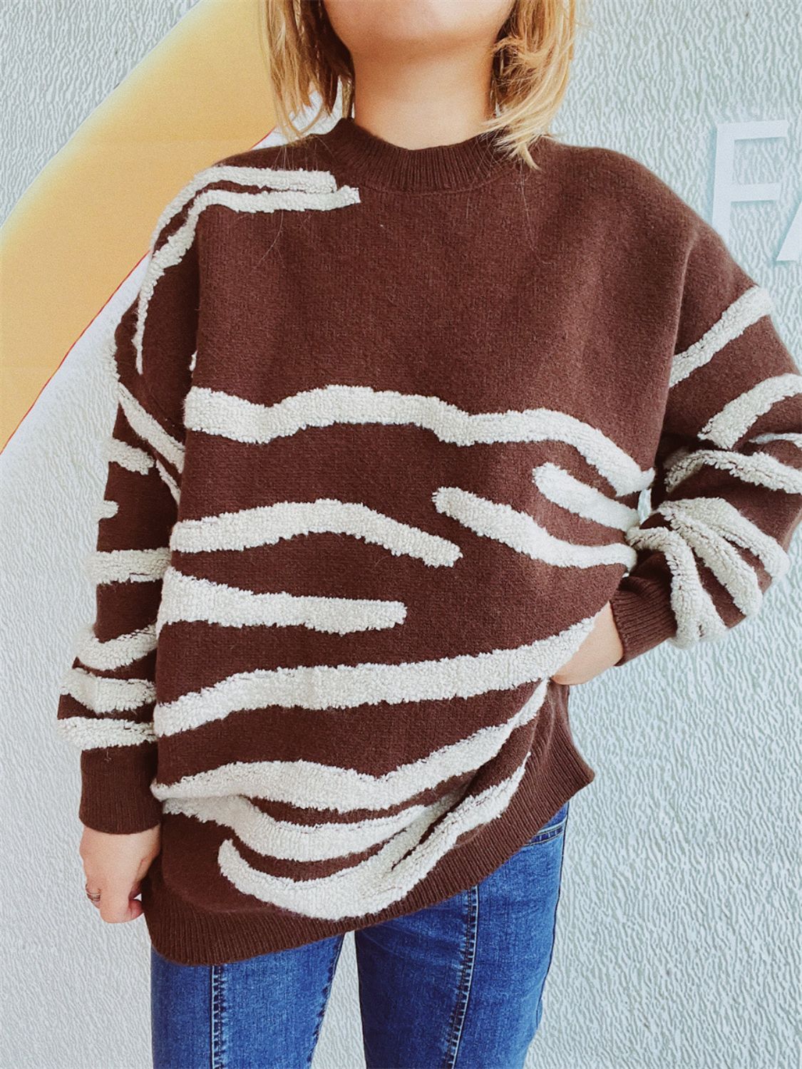 Brown acrylic crewneck sweater with textured white stripes, crew neck, long sleeves.