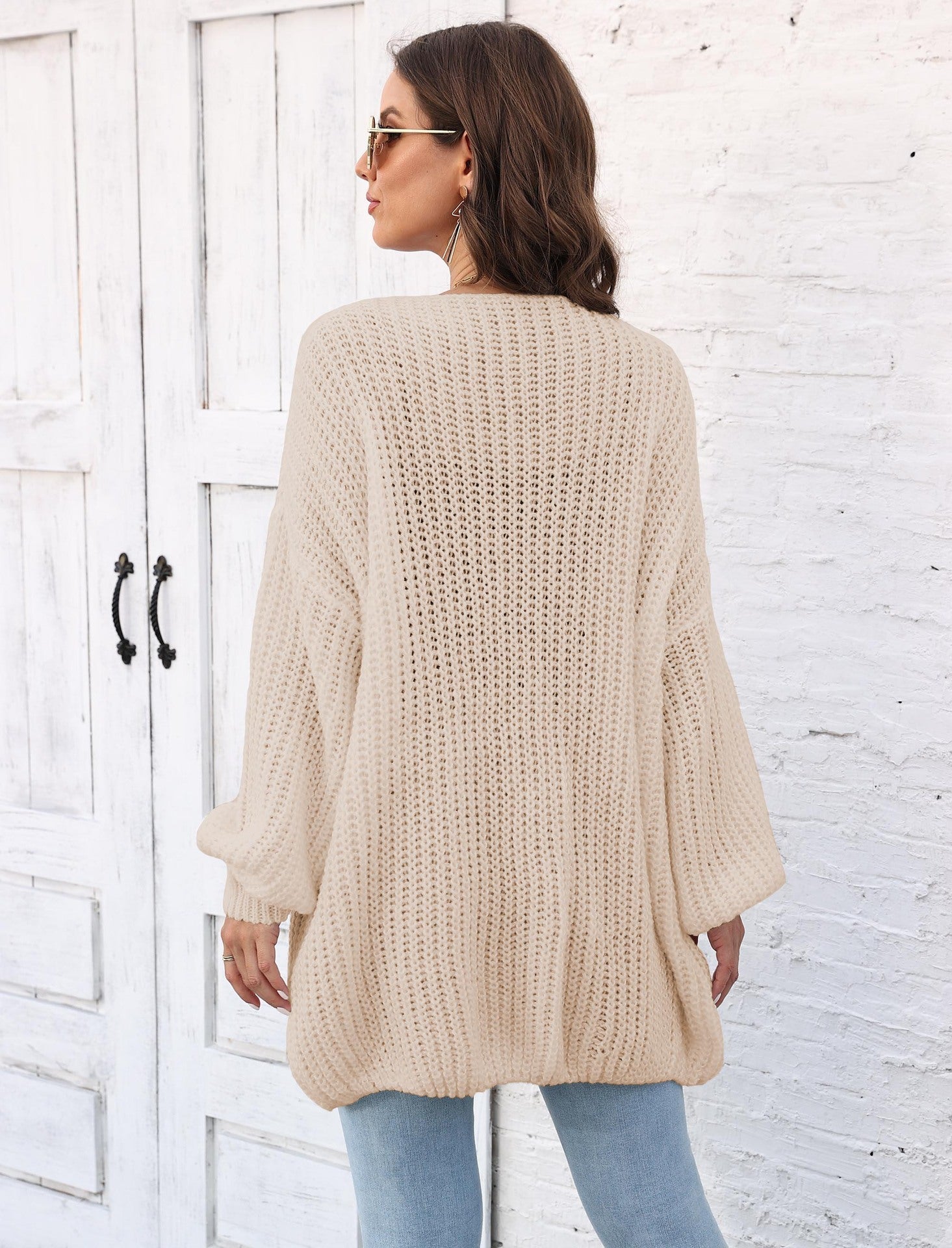 Tan balloon sleeve cardigan with pearl buttons and ribbed knit texture.