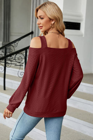 Burgundy textured open shoulder blouse with square neckline and long sleeves.