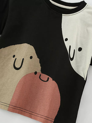 Toddler color-block cotton tee with cute face graphic in black and cream.