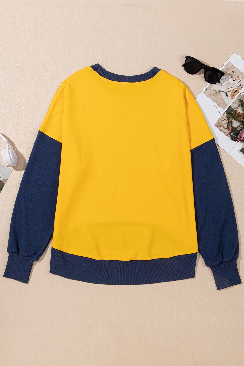 Yellow crewneck sweatshirt with contrast navy blue sleeves and hem.