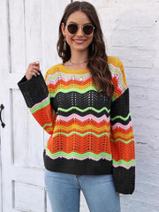 Crochet sweater with rainbow wave pattern, crew neck, and bell sleeves.