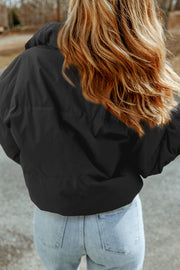 Black padded crop jacket with stand collar, shown from the back.