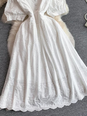 White lace-embellished midi dress with puff sleeves and button detail.