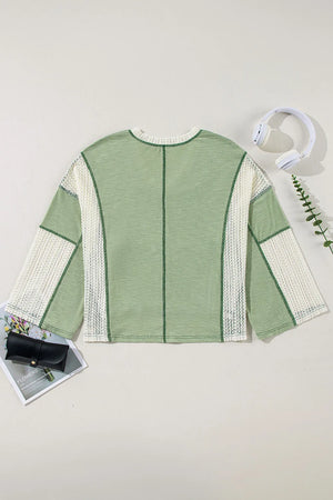Textured patchwork tunic top in gum leaf green with white crochet sleeves and V-neck.