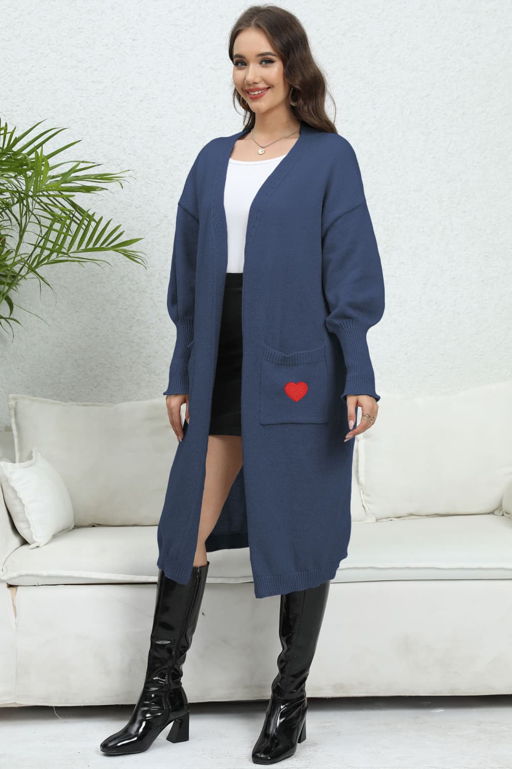 Dark blue long cardigan with balloon sleeves and a red heart embroidered pocket.