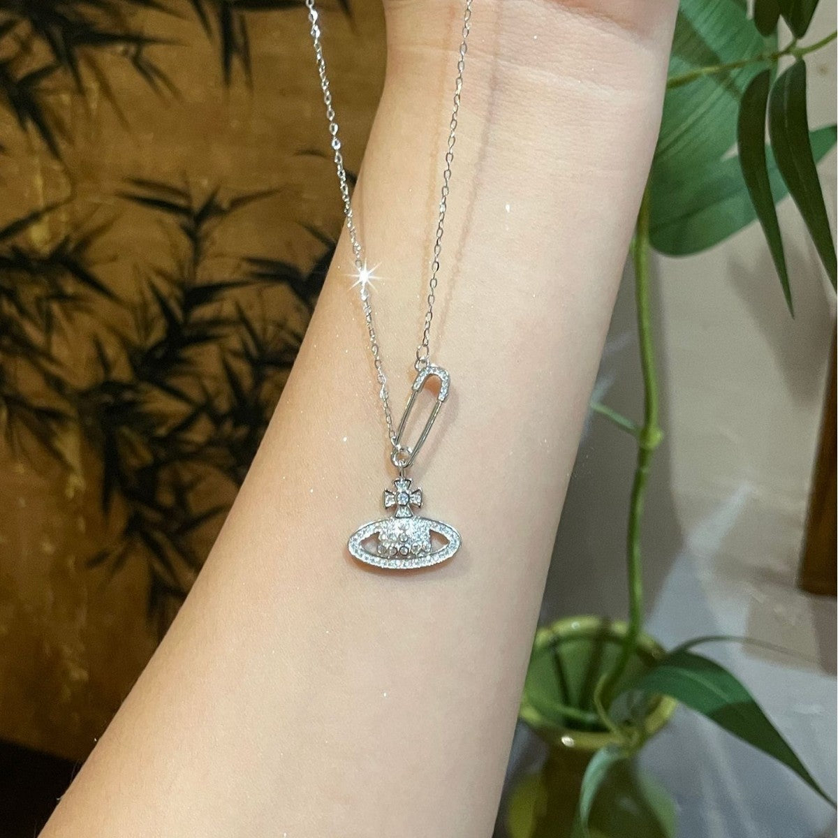 Radiant Orb Pendant Necklace in Silver with safety pin detail.