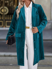 Deep Teal velvet longline trench coat with lapel collar and buttoned front.