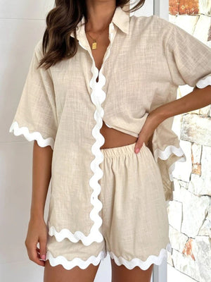 Beige linen lounge set with scalloped white trim on shirt and shorts.