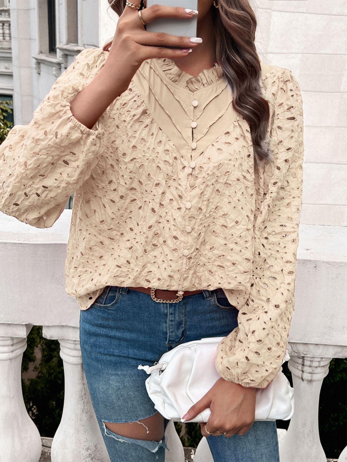 Tan eyelet embroidered blouse with ruffle collar and button front.