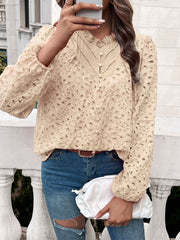 Tan eyelet embroidered blouse with ruffle collar and button front.