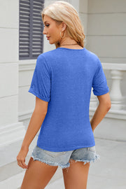Asymmetric button-up tee in blue with cuffed short sleeves.